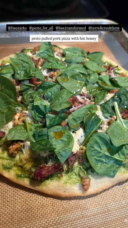 Instagram story showing a flatbread pizza with pesto, pulled pork, and fresh spinach